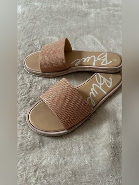 rose gold slip-on sandals with a rhinestone-covered strap.